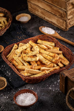 Homemade salt sticks with cummin in little wicker basketの写真素材