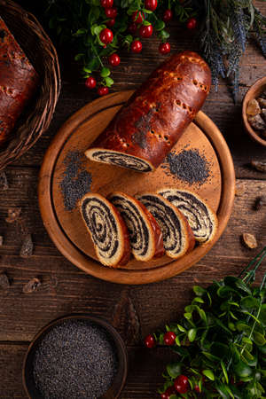 Beigli, Hungarian poppy seed rolls for Christmas table on wooden boardの写真素材