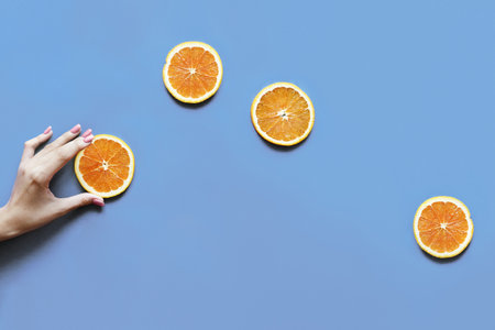 Delicious orange citrus fruit slices flat lay backgroundの素材