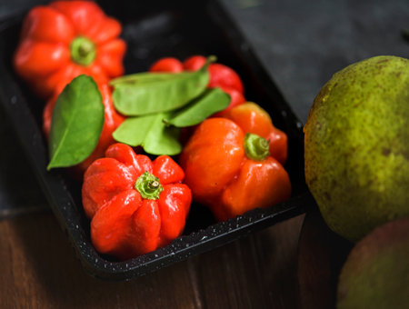 Fresh red pepper in a black plastic containerの素材