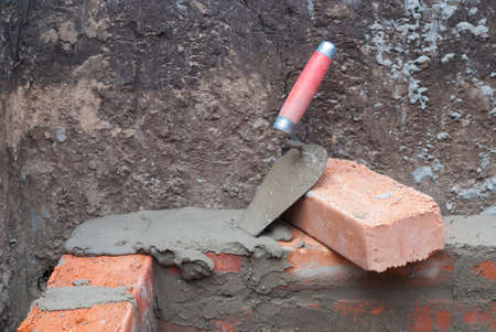 against the background of the brickwork is trowelの写真素材