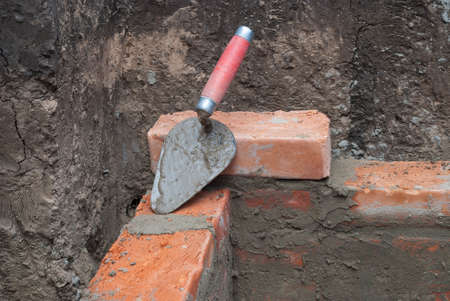 against the background of the brickwork is trowelの写真素材