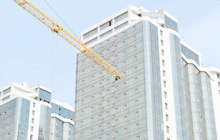 boom crane on the background of new buildingsの写真素材