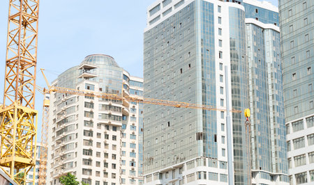 boom crane on the background of new buildings