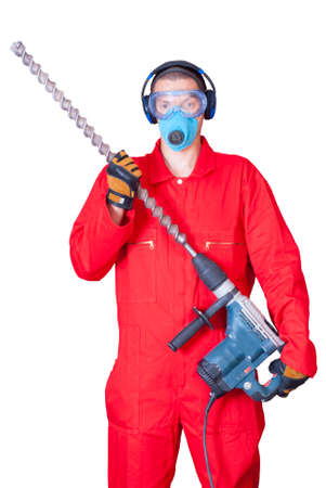 a man in overalls holding a hammer with a huge drillの写真素材