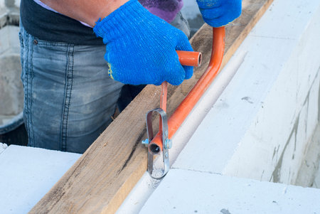 Builder makes a groove in aerated concrete