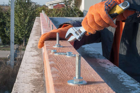 Builder Laying nets attached to a wooden beam mauerlatの写真素材