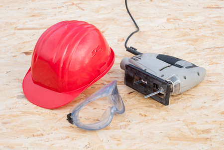 construction tools lying on a sheet of plywood OSBの写真素材