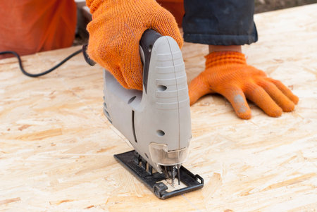 construction jigsaw to cut a sheet of plywood OSB