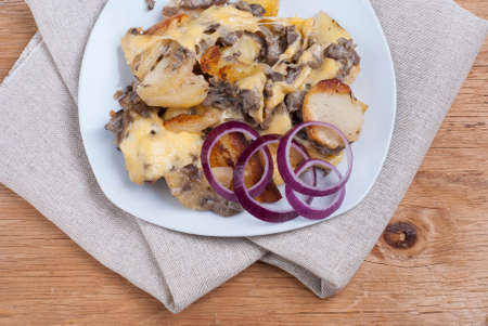 stewed potatoes with mushrooms and melted cheeseの写真素材