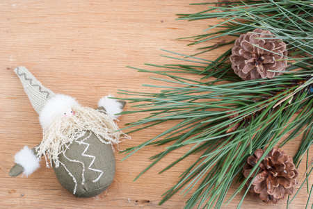 background with a pine branch on a wooden textureの写真素材