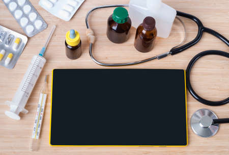 background tablet on the table and medicinesの写真素材