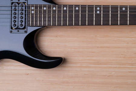 black guitar on the background of wood textureの写真素材