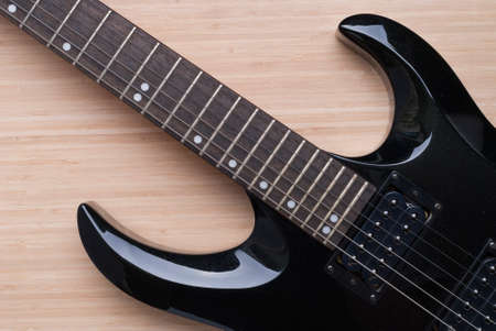 black guitar on the background of wood textureの写真素材
