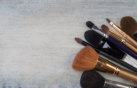 background various women's beauty accessories lie on denim
