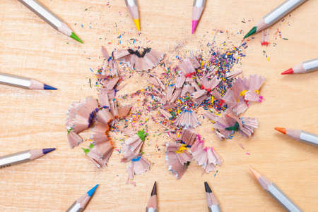 shavings and colored pencils on a tableの写真素材