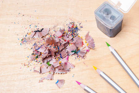 shavings, colored pencils and pencil sharpener on a tableの写真素材