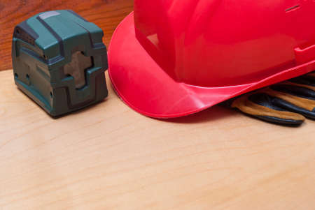 construction helmet, gloves and laser level on the tableの写真素材
