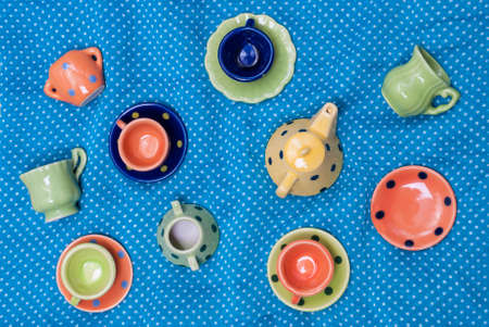 many colored ceramic dishes laid out on a blue backgroundの写真素材