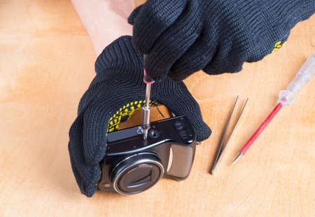 master at work repairing a digital cameraの写真素材