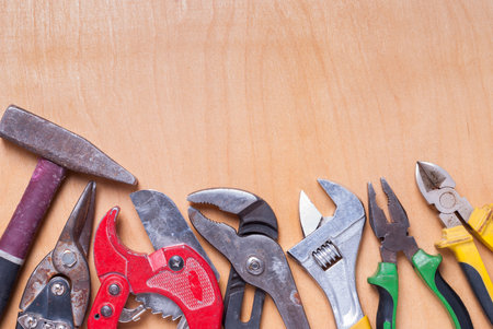 old hand tools on a wooden background