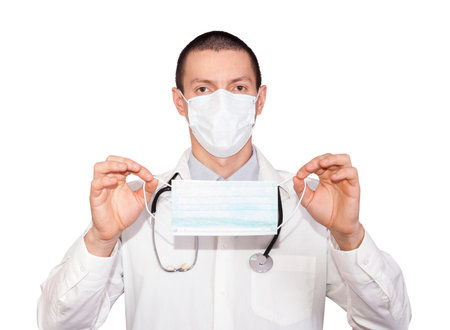 young male doctor holding a medical protective mask