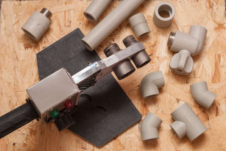 polypropylene pipes, fittings and welding machine in the background OSBの写真素材