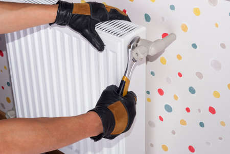 plumber to connect the heating radiator to a polypropylene pipeの写真素材