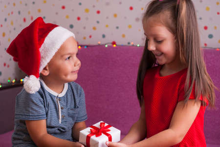 little boy gives a gift to his sisterの写真素材