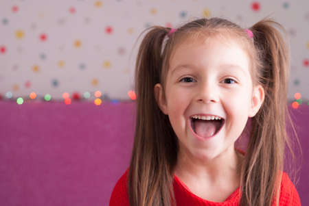 cute little girl in a red dressの写真素材