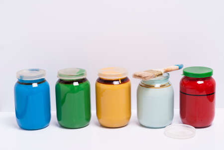 cans with paints and brush on a white backgroundの写真素材