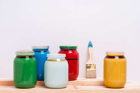 cans with paints and brush on a white backgroundの写真素材