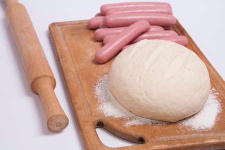process of home-cooking sausages in a doughの写真素材