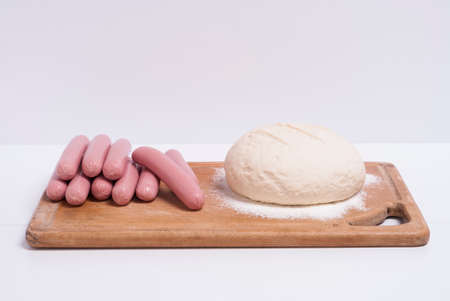 process of home-cooking sausages in a doughの写真素材