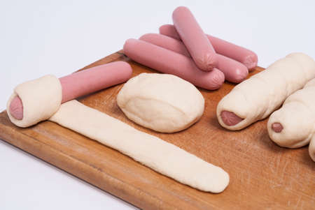 process of home-cooking sausages in a doughの写真素材