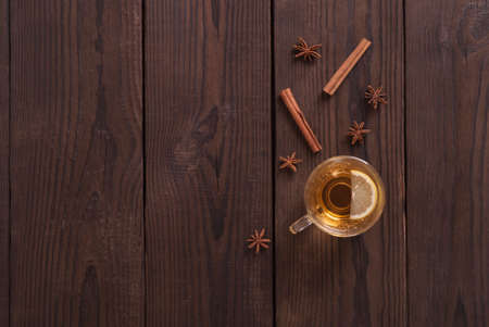 cup of tea on a wooden background and spicesの写真素材