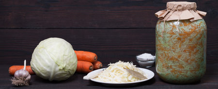 sauerkraut and fresh vegetables on a wooden background