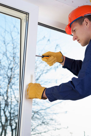 professional worker repairs metal plastic window