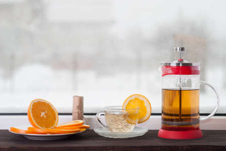 teapot and cup with tea and orangeの写真素材