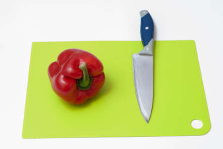 paprika, knife and cutting board on white tableの写真素材
