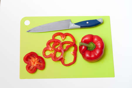 paprika, knife and cutting board on white tableの写真素材