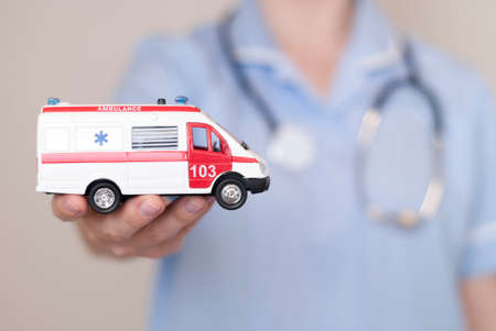 woman doctor holding model of ambulance carの写真素材