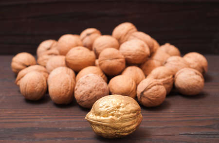 One Golden nut among a group of ordinary nuts. Leader, individuality, best worker, best employee, team. Business conceptual image.の写真素材
