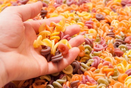 organic multicolored spiral pasta. food multicolored background
