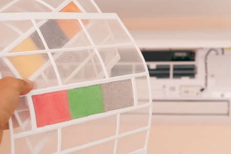 master holds in his hand new filters for air conditioningの写真素材