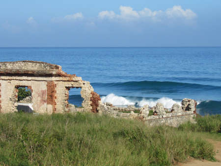 old building ruins destroyed with sea and sky behindの写真素材