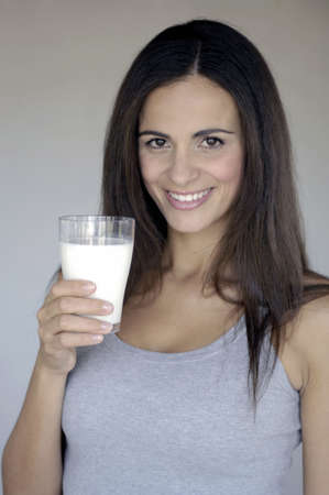 Portrait of woman drinking milkの写真素材