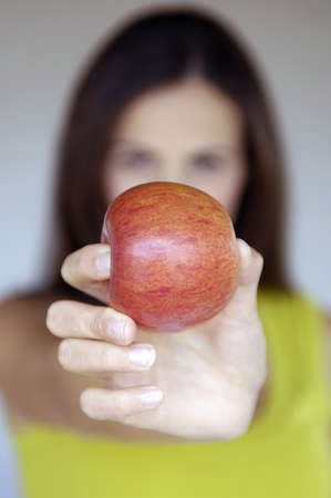 fingers holding an appleの写真素材