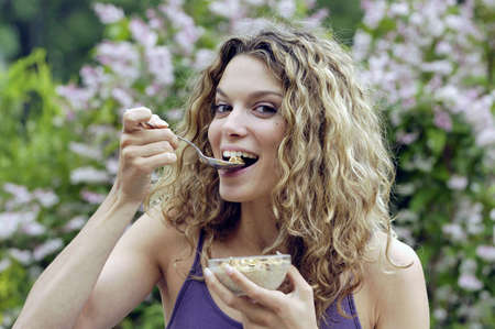 Happy woman eating yogurthの写真素材