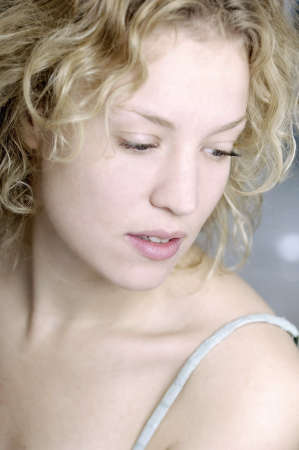 blond woman turning faceの写真素材